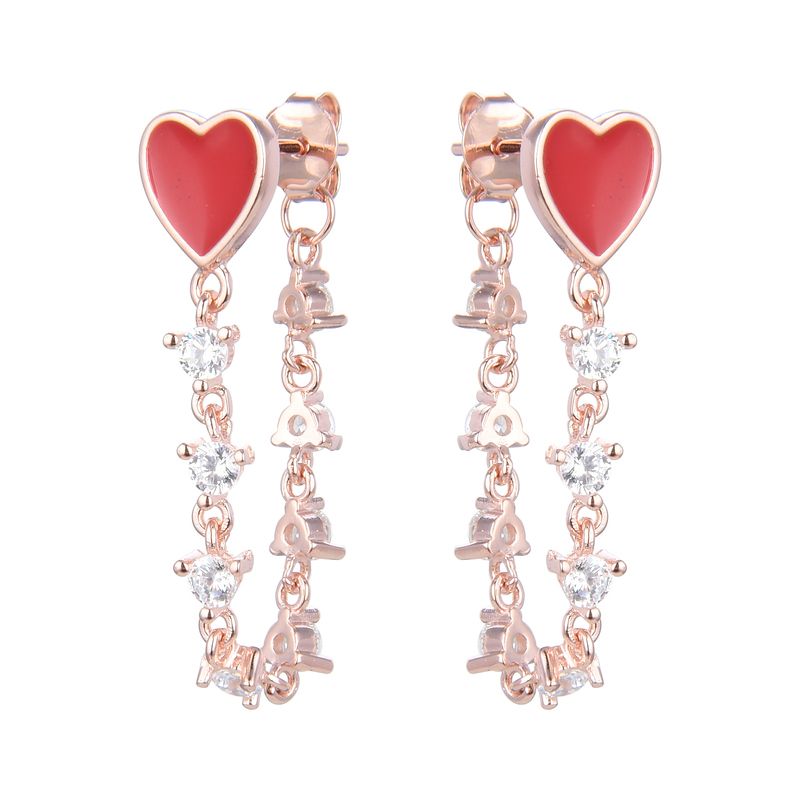 Studs de plata bañados en rose gold con piedreria y corazones rojos
