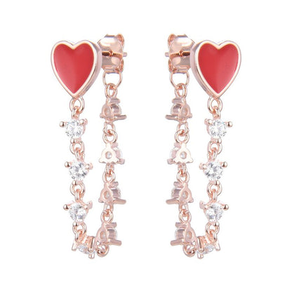 Studs de plata bañados en rose gold con piedreria y corazones rojos